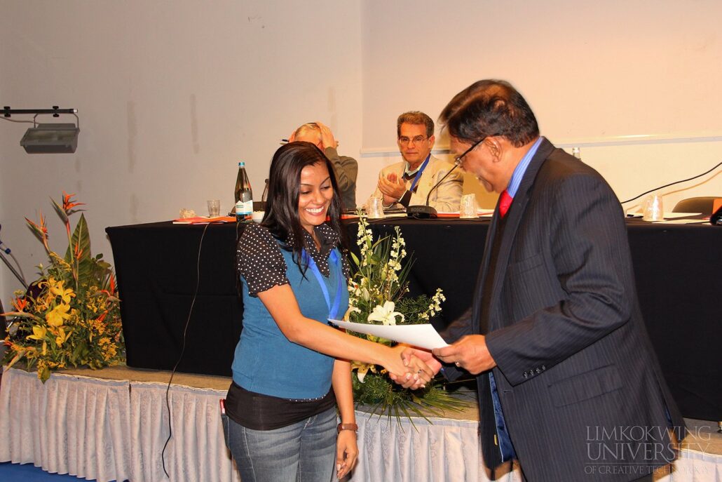 Melissa receiving Appreciation Certificate from Sir Augustine Loorthusamy, former SIGNIS World President.