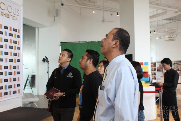 DSP Zulkipli Hj. Daud of the Royal Malaysia Police reviews the artworks made by students for the 'Be Smart' cybercrime campaign