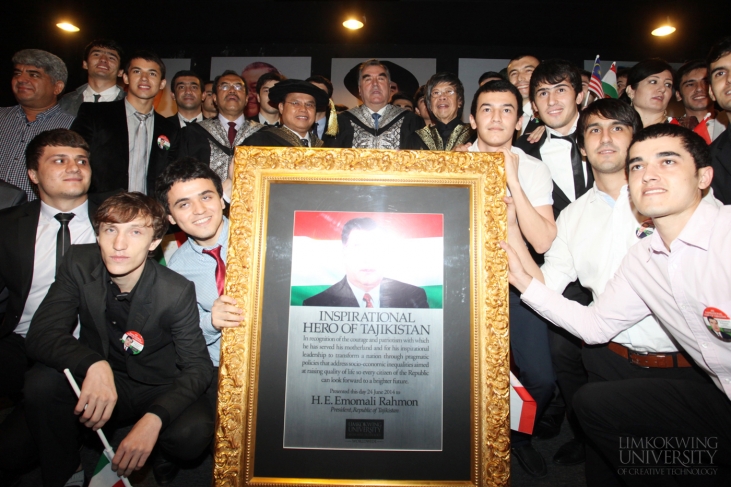 H.E Emomali Rahmon with Tajik students holding a plaque he received from the University