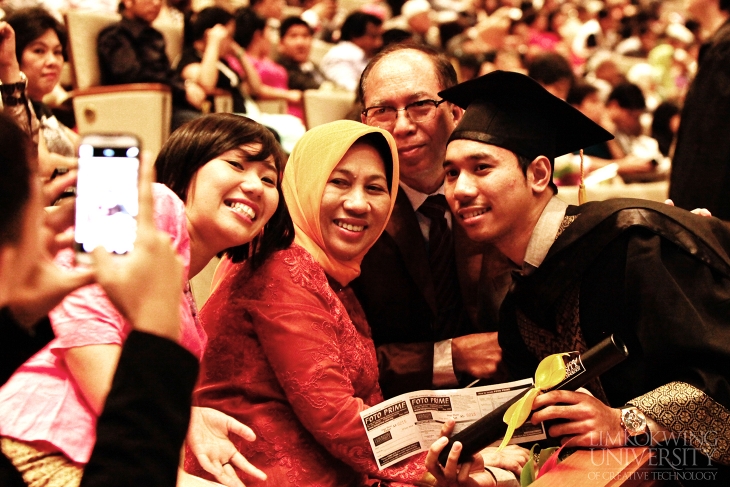 Happy graduates with their families