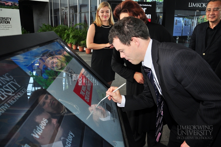 Mr. Stuart Wells signing the digital welcome board