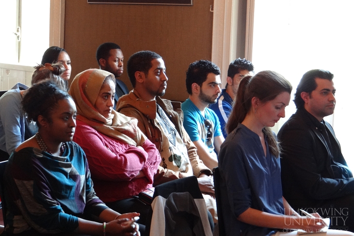 The participants listening attentively to the presentation at the forum