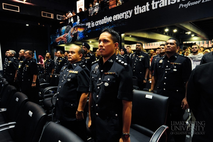 High ranking police officials standing to the RMP's official anthem, 'Sedia Berkhidmat'