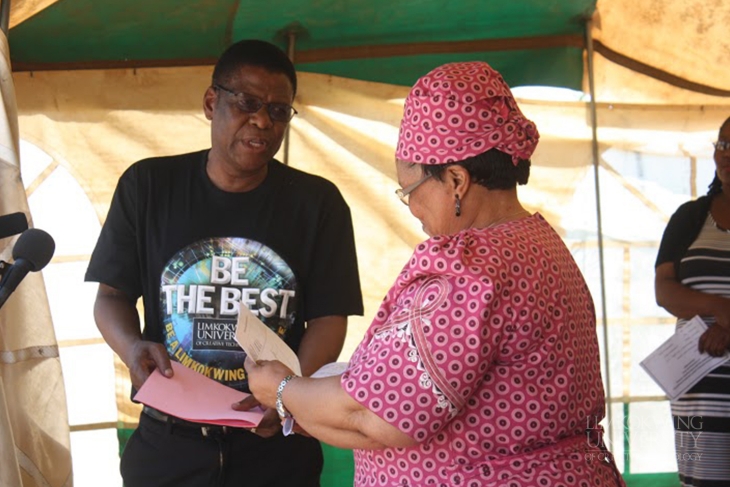 Registrar Mr. Moroka Hoohlo handing over the Architecture structures to the Minister